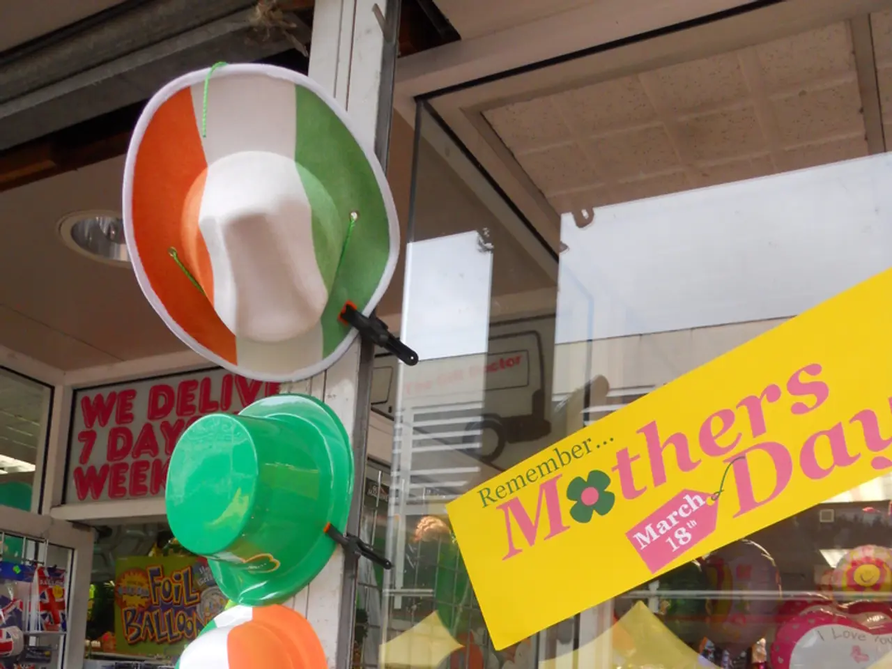 In this picture I can see a shop, where there is a board, light, there are hats, flower vases, a...