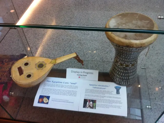 Zooey Deschanel elegantly arranges her guitars, sparking ideas for me to reconsider my bare walls.