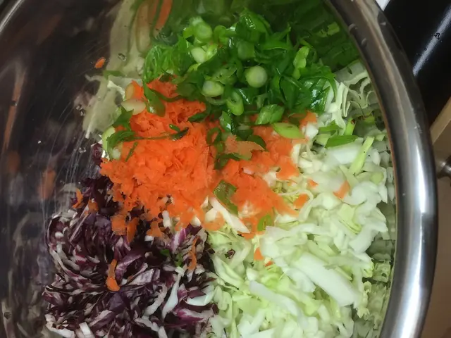 In this image we can see the vegetables, cut and kept in the steel bowl which is placed on the...
