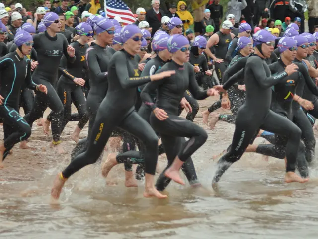 In this image there are persons running wearing a swimsuit in the water. In the background there...