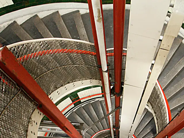 In this picture we can see stairs, railing and pipes.